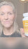 Person holding a bottle of Brain Optimal supplement in front of a neutral background
