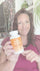 Woman holding a bottle labeled 'NAD+ Optimal' in an indoor setting.